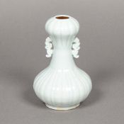 A Chinese porcelain twin handled vase With onion neck, the ribbed body with celadon glaze. 14.