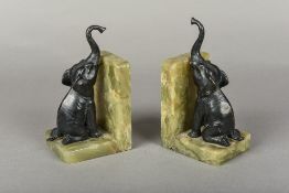 A pair of Continental bronze mounted onyx bookends Each worked with the figure on an elephant.