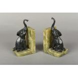 A pair of Continental bronze mounted onyx bookends Each worked with the figure on an elephant.