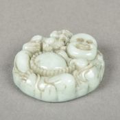 A Chinese carved celadon jade pendant Worked with the figure of Buddha and a temple lion. 4.