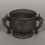 A Chinese cast metal censor Typically cast with archaistic motifs. 14 cm high.