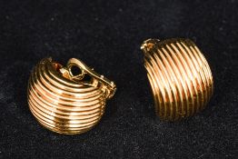 A pair of Asprey and Garrard 18 ct gold ear clips Each of scrolling shell form. Each 2.25 cm high.