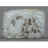 A Chinese carved pale jade pendant Worked with a bird amongst prunus blossom. 4.5 cm long.