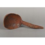 A 19th century Scandinavian carved treen ladle The hooked handle with scrolling foliate carving.
