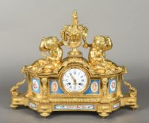 An ormolu Sevres type panel inset mantel clock The indistinctly signed white enamelled dial with