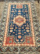 A Caucasian wool prayer rug The midnight blue mihrab field enclosing a central medallion