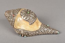 A Tibetan mineral set and white metal mounted conch shell The mounts decorated with various animals