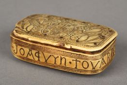 An 19th century carved horn snuff box The hinged lid carved with a crest amongst floral scrollwork,