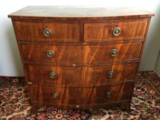 A George III line inlaid mahogany bow front chest of drawers The shaped top above two short and