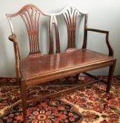 A Victorian mahogany double chair back settee The scrolling top rails above pierced back splats,