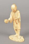 A 19th century Japanese carved ivory okimono Worked as a figure holding a puffer fish,