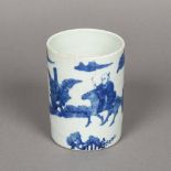 A Chinese blue and white porcelain brush pot Decorated in the round with a procession of figures.