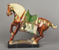 A large antique Chinese Tang style pottery horse Of typical form, with mottled glazed decoration,