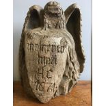 A 17th century carved oak memento mori Worked as an angel holding a shield inscribed Memento Mori