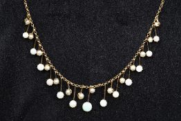 An Edwardian 9 ct gold opal and seed pearl necklace Set with interspersed opal and seed pearl drops.