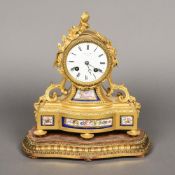 A 19th century French porcelain mounted ormolu mantel clock The white enamelled dial with Roman