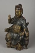A Chinese gilt and polychrome decorated cast bronze figure of an emperor Modelled seated on a