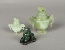 A Chinese carved jade twin handled censor and cover Together with another smaller;