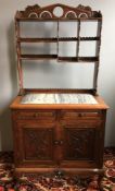 A 19th century Chinese carved hardwood side cabinet The pierced galleried shelf section above the