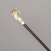 A 19th century cane The gem set yellow metal mounted carved ivory handle worked as an eagle's head.