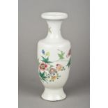 A Chinese porcelain vase Of baluster form, decorated with a bird amongst floral sprays.