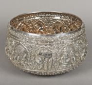An unmarked Indian silver bowl Repousse decorated in the round with various deities,