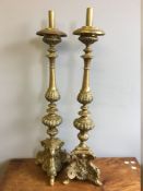 A pair of 19th century brass altar sticks Of typical form with embossed decoration. 90 cm high.