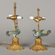 A pair of Chinese table lamps Each carved giltwood base surmounted with a jade bird.