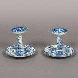 A pair of Chinese blue and white porcelain candle stands Each decorated with phoenixes and bamboo