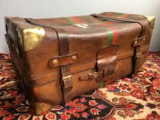 A vintage leather travelling trunk Set with brass corners plates and with red and green painted