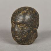 An archaistic type carved stone head Modelled as a bald male. 4.5 cm high.