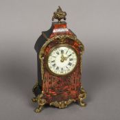 A late 19th century ormolu mounted boulle mantel clock With fruiting tazza finial above the arched