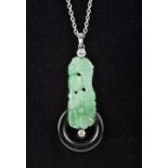 An Art Deco diamond set platinum mounted carved jade and onyx pendant Mounted on a platinum chain.