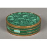 A malachite mounted brass box and cover Of circular section. 13.5 cm diameter.