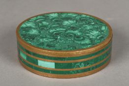 A malachite mounted brass box and cover Of circular section. 13.5 cm diameter.