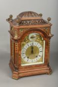 A Victorian walnut cased mantle clock The 5 1/2 inch arched brass dial with silvered chapter ring,