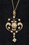 An Edwardian 15 ct gold seed pearl set pendant Of scrolling floral form,