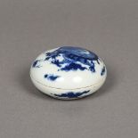 A Chinese blue and white porcelain box and cover Of circular form, decorated with a dragon.