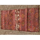 A Caucasian wool saddle bag rug Decorated with latch hook lozenges. 124 x 67 cm.