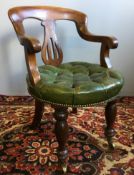 A Victorian leather upholstered mahogany desk chair The arched top rail above the pierced vase