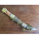 A Persian stained and decorated ivory handled dagger The curved steel blade with silver and gold