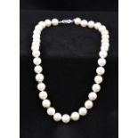 A pearl necklace Mounted with diamond set roundels and 18K white gold clasp.