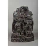 A Chinese carved hardwood group Worked as figures and sages beneath a pine tree,