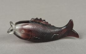 A Chinese carved amethyst glass snuff bottle Worked as a carp. 10.5 cm long.
