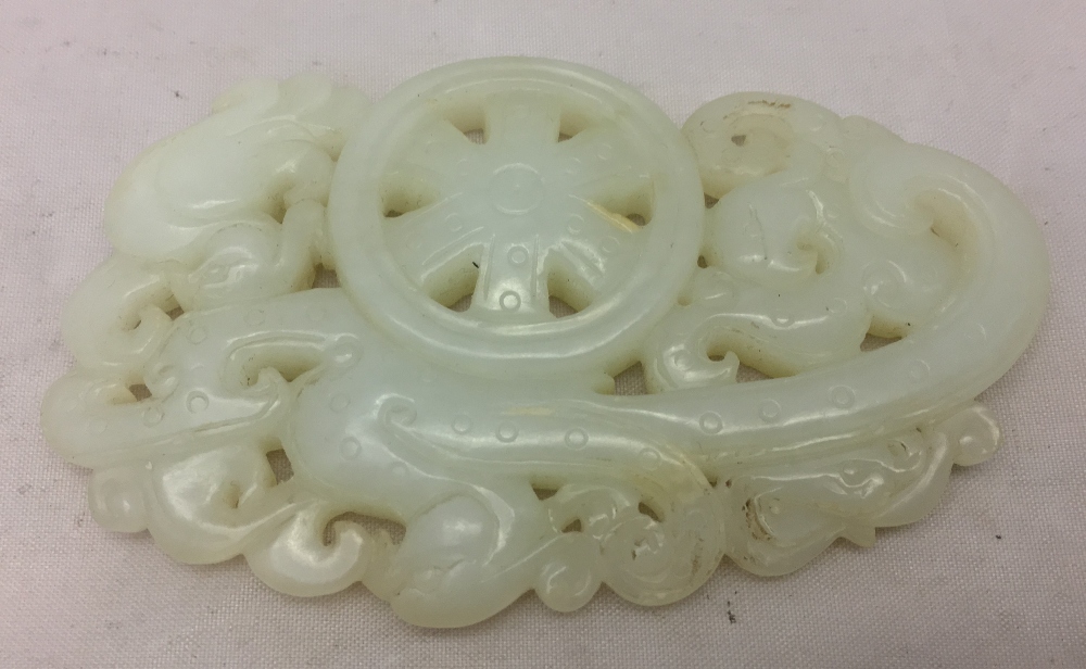 A Chinese carved celadon jade group Worked with stylised phoenixes flanking a spoked wheel. 8. - Image 2 of 4