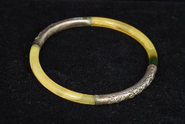 A Chinese white metal mounted bangle The two mounts with geometric and floral decorations.