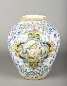 A Continental Majolica jar Typically decorated with a cherub vignette and foliate scrolls.