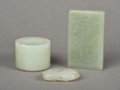 A Chinese carved celadon jade archer's ring Together with a carved celadon jade pendant tablet,