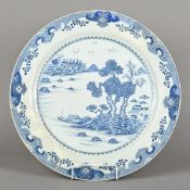 A Chinese blue and white porcelain charger Decorated with a mountainous lakeland scene.