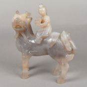 A Chinese carved onyx group Worked as a young sage riding a Qilin. 21.5 cm high.